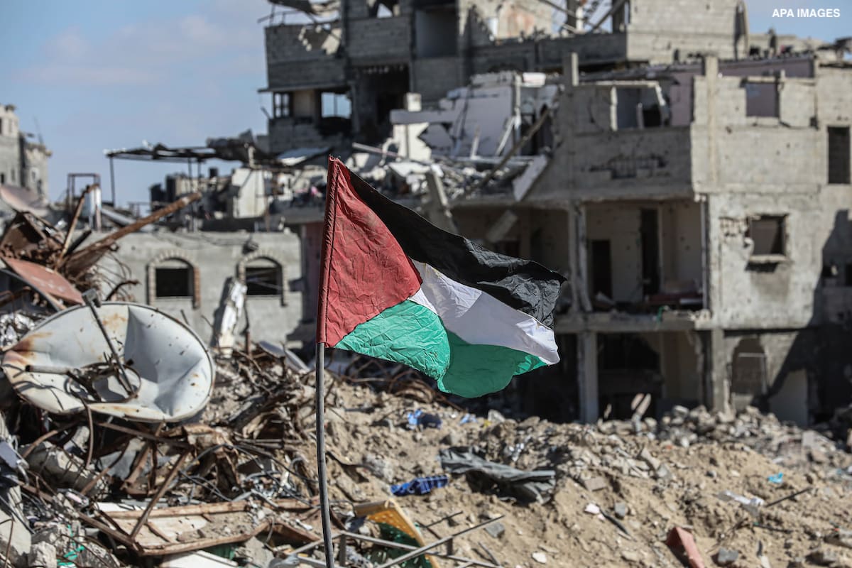 Internally displaced Palestinians inspect their destroyed houses in Rafah, southern Gaza Strip