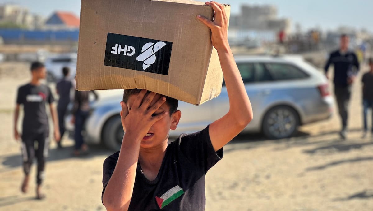 Palestinians seeking aid gather near an aid distribution site run by the U.S.-backed Gaza Humanitarian Foundation