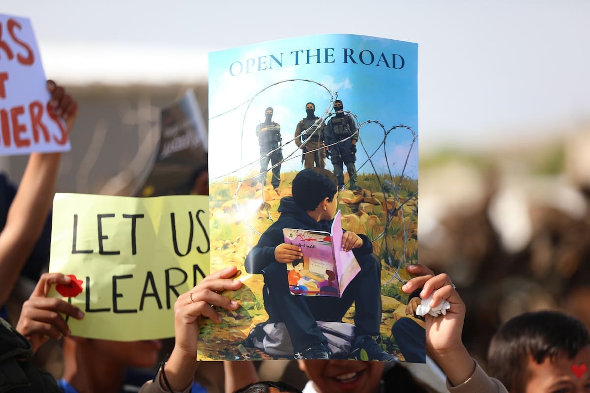 Palestinian students continue their sit-in and study on the side of a road, which has been closed by settlers and Israeli forces, preventing them from reaching their schools, in the village of Umm al-Khair in Masafer Yatta,